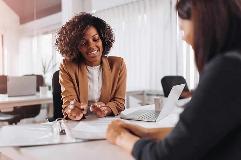 Image of African-American female consultant speaking with a client 